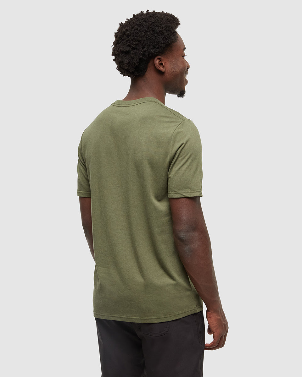 Man wearing olive green Tentree t-shirt, back view against white background