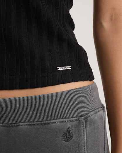 Black ribbed tank top with Volcom logo label on model