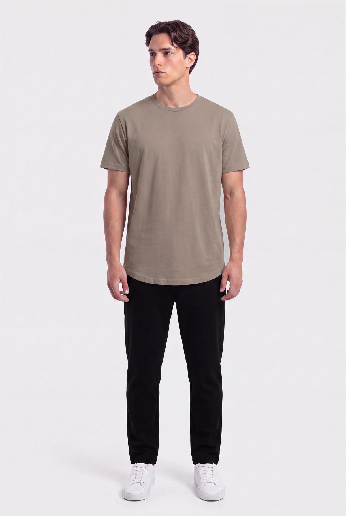 Man wearing a khaki basic crew neck t-shirt with black pants and white sneakers