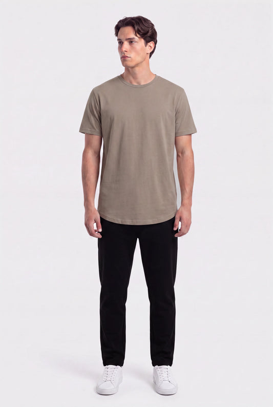 Man wearing a khaki basic crew neck t-shirt with black pants and white sneakers