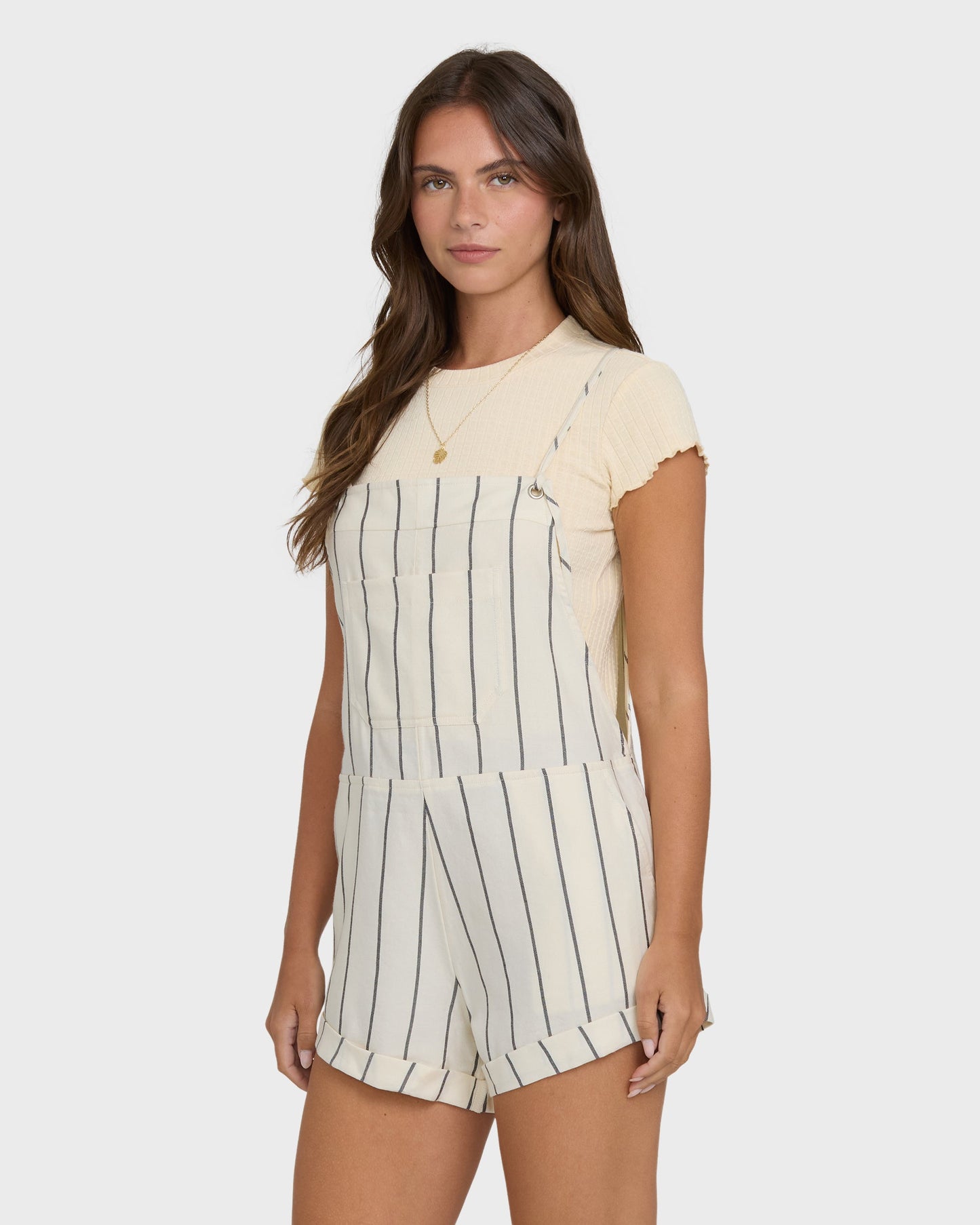 Billabong Wild Pursuit Overall YD in White Cap cream striped short overalls worn over tee
