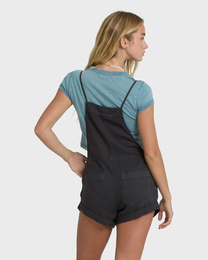 Billabong Wild Pursuit Overall Solid in off-black worn over teal tee, back view