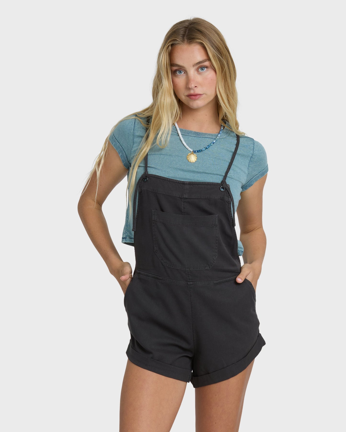 Billabong Wild Pursuit Overall Solid in Off Black worn over blue tee by blonde model