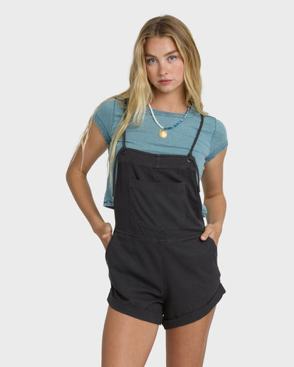 Billabong Wild Pursuit Overall Solid in Off Black worn over blue tee by blonde model
