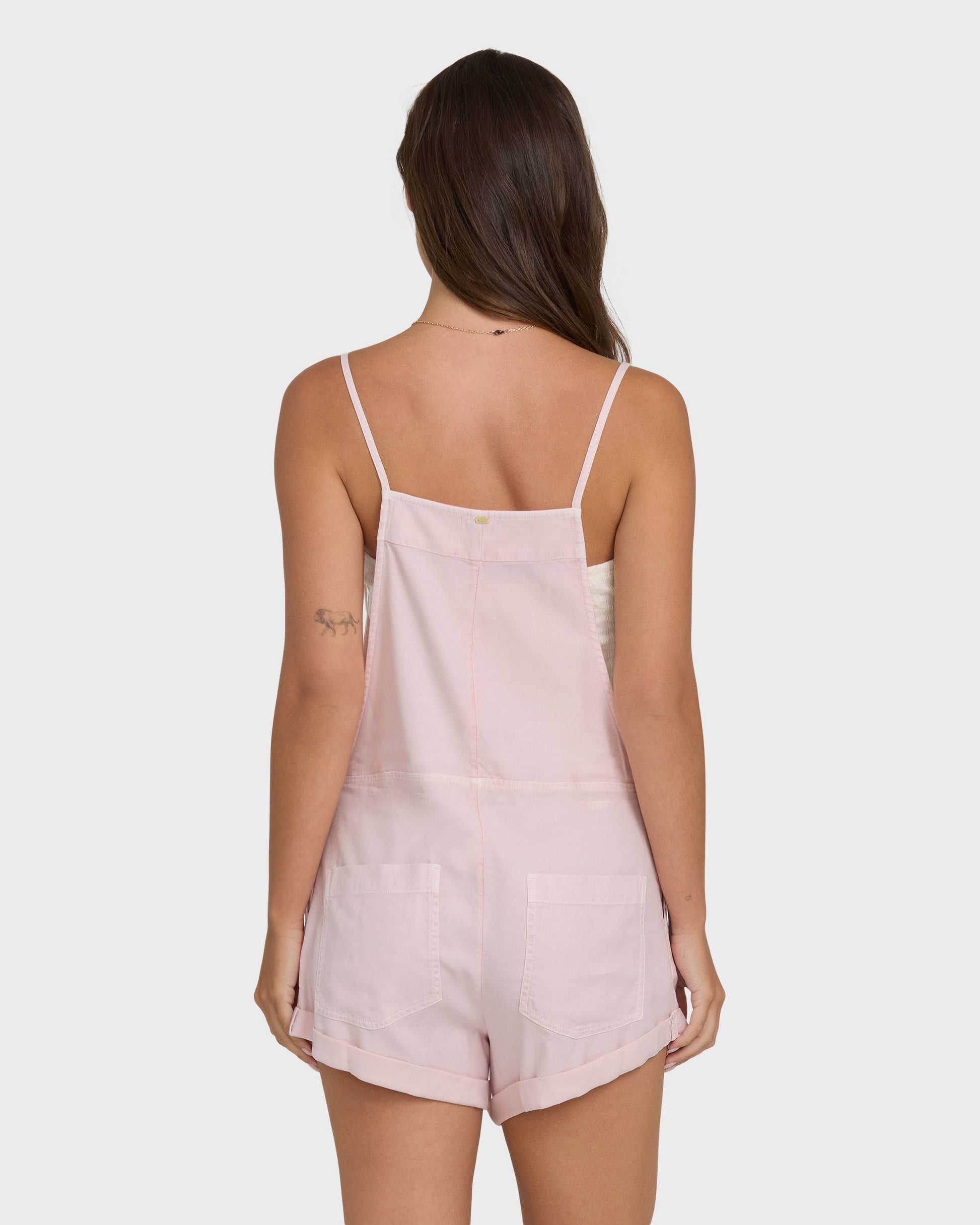 Back view of Billabong Wild Pursuit Overall Shorts in rosewater pink on model