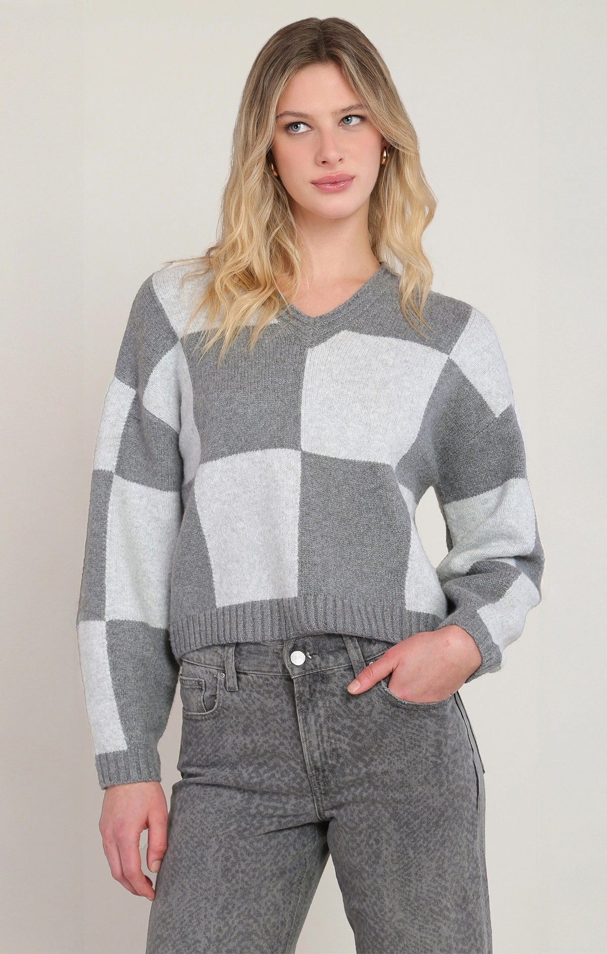 Dex women's heather grey colorblock v-neck sweater with large checker pattern and grey jeans
