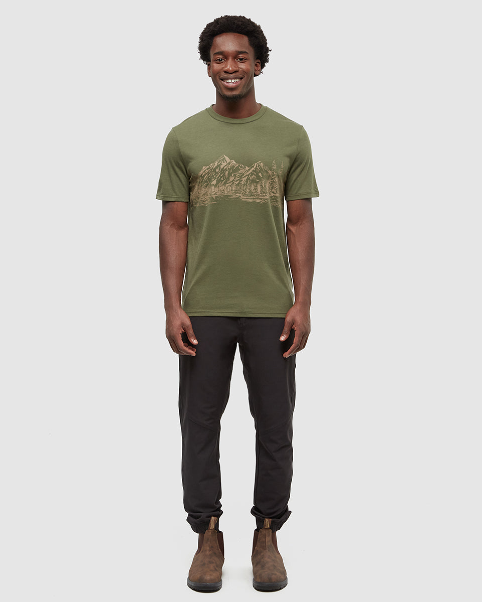 Man wearing olive green Tentree t-shirt with mountain graphic design
