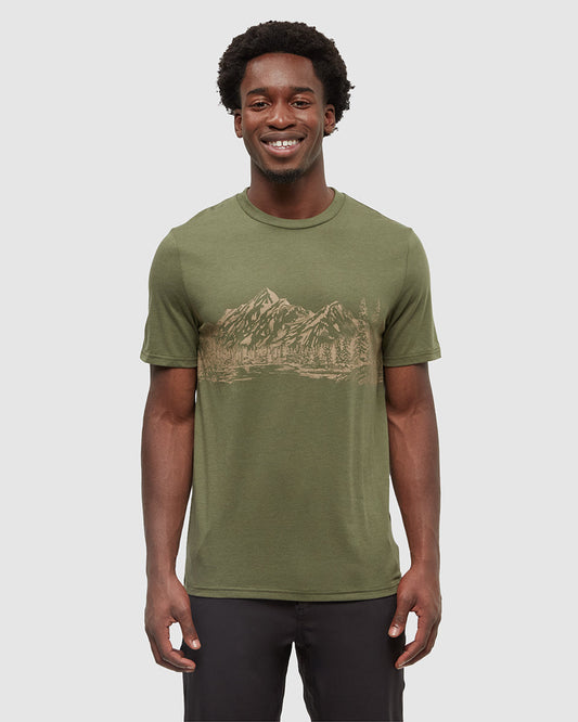 Man wearing olive green Tentree t-shirt with mountain landscape graphic print