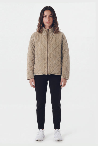 TeamLTD Northway Quilted Jacket in Washed Khaki worn by female model with black pants