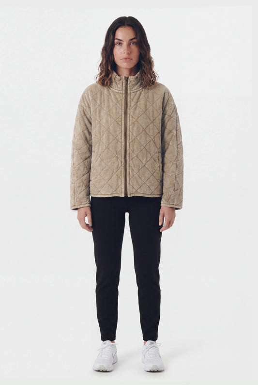 TeamLTD Northway Quilted Jacket in Washed Khaki worn by female model with black pants