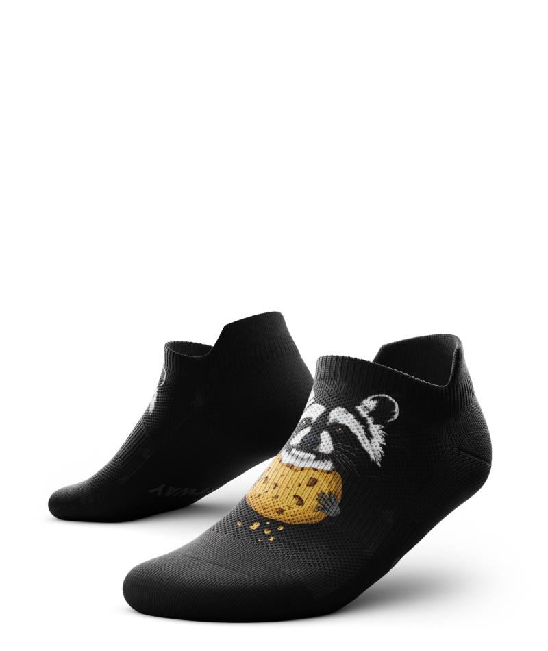 Outway Rad Raccoon black ankle socks featuring illustrated raccoon holding a cookie graphic