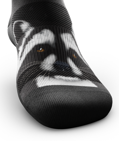 Outway Rad Raccoon low-cut sock featuring detailed black and white raccoon face print on dark background