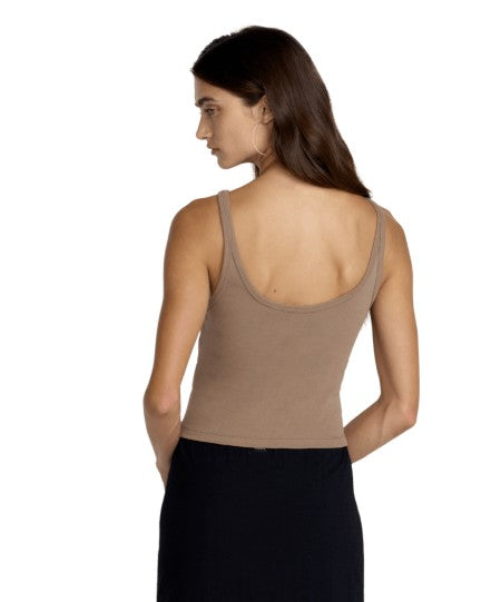 Woman wearing brown fitted tank top, back view studio shot