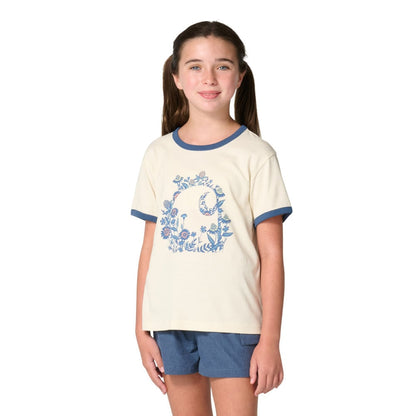 Girl wearing Carhartt Kids cream ringer tee with blue floral C graphic and denim shorts