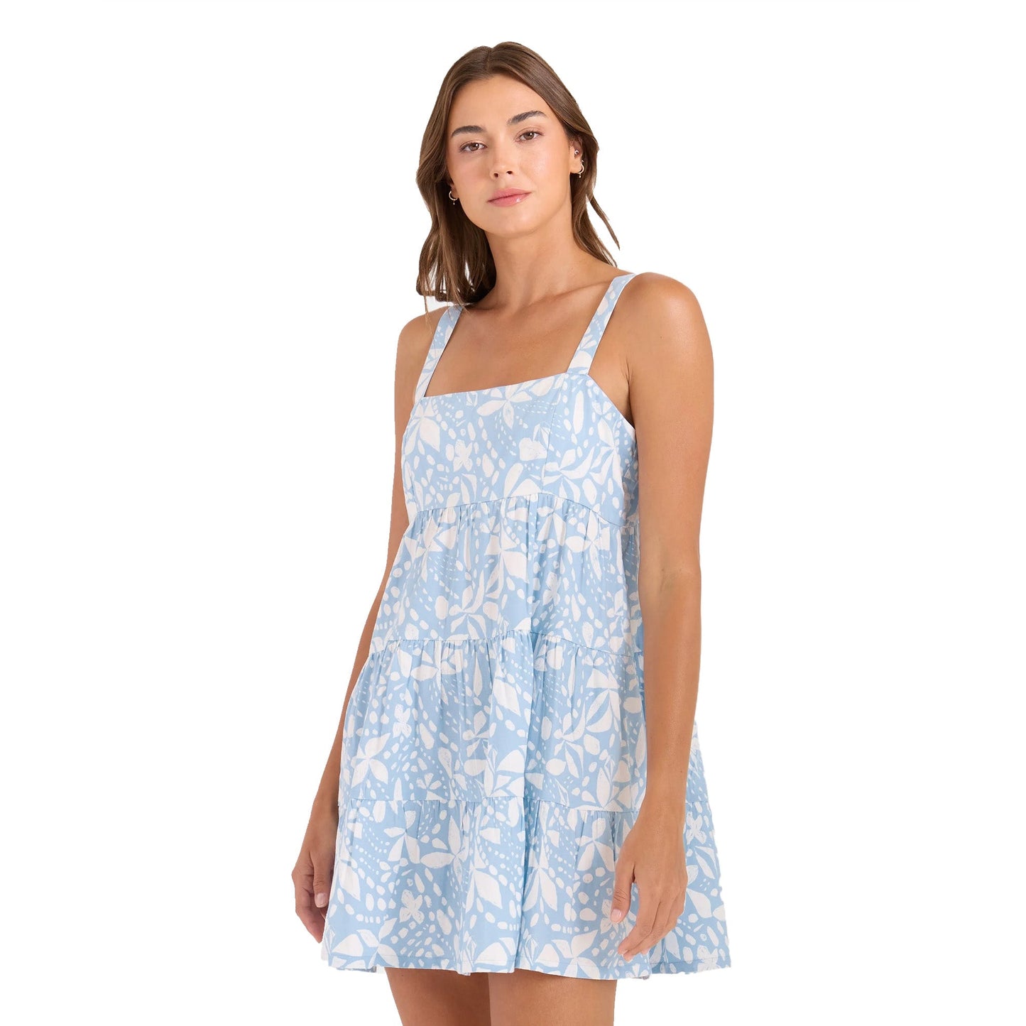 Woman wearing light blue floral print sleeveless tiered mini dress with straps