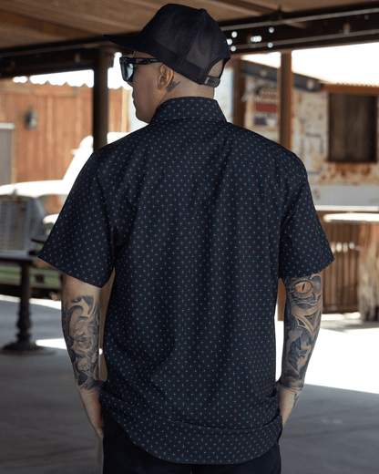Dixxon High Desert Party Shirt in black with dot pattern, back view on tattooed model