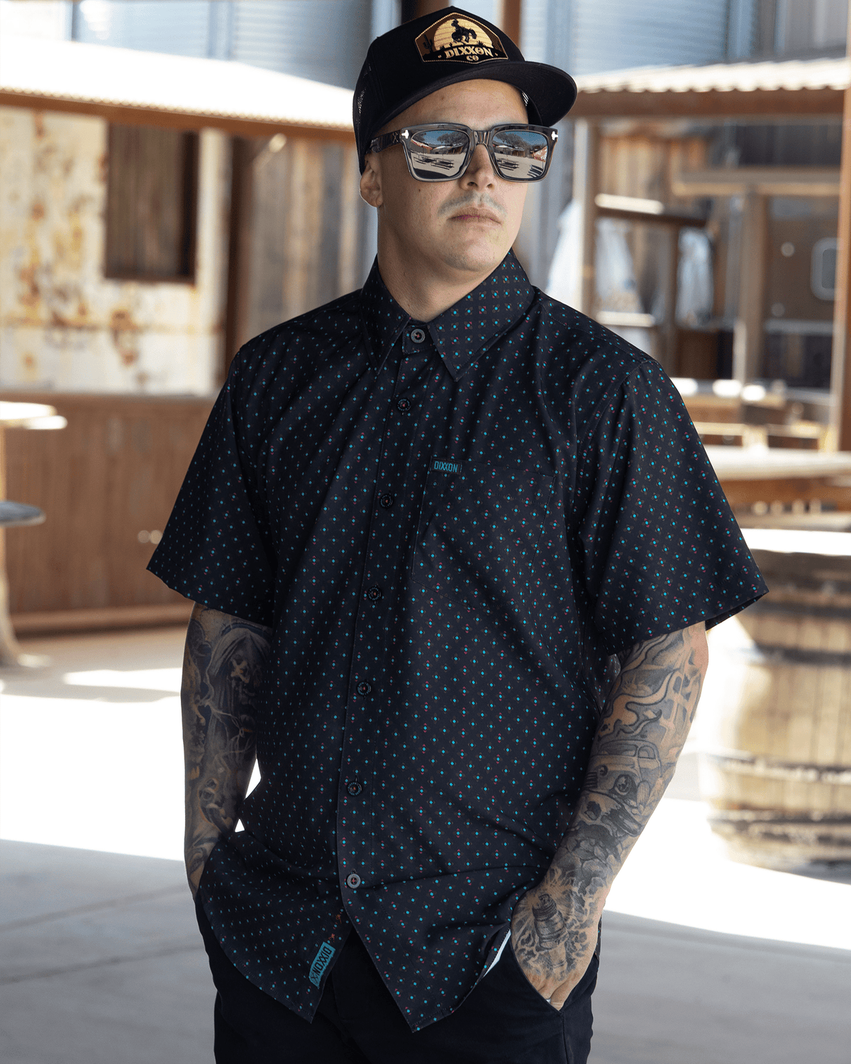 Dixxon High Desert Party Shirt short sleeve black button-up with teal dot pattern on male model