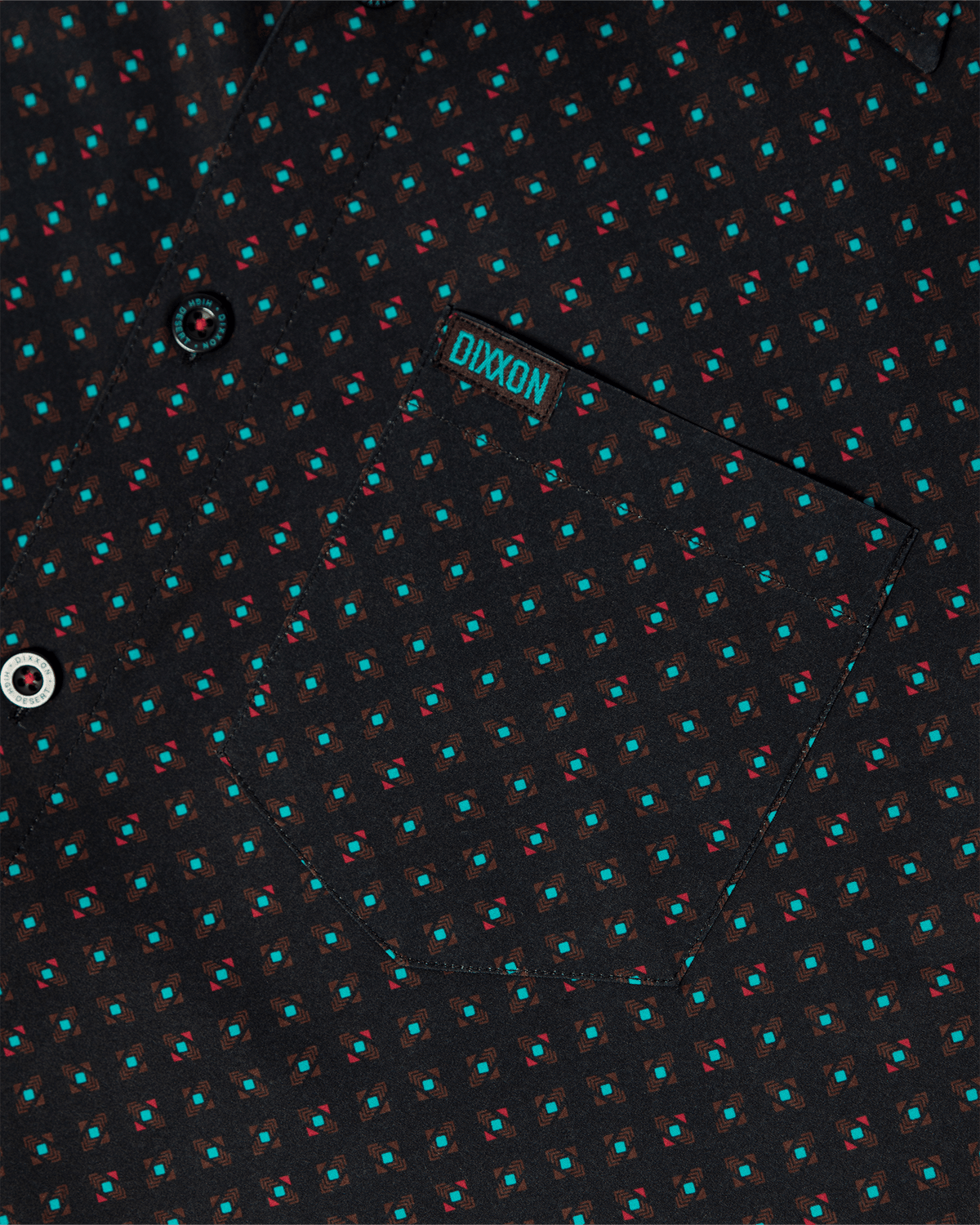 Dixxon High Desert Party Shirt close-up showing geometric teal and red pattern on black fabric with chest pocket
