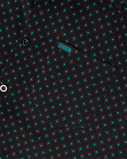 Dixxon High Desert Party Shirt close-up showing geometric teal and red pattern on black fabric with chest pocket