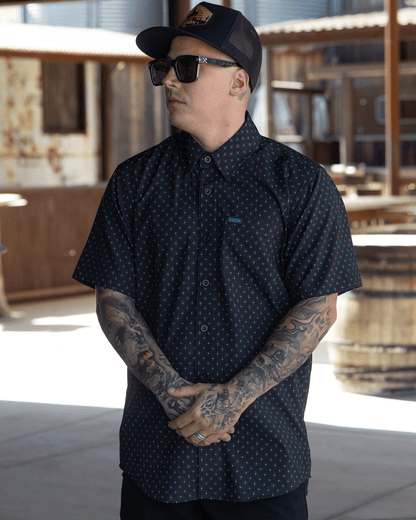 Dixxon High Desert Party Shirt short sleeve button-up in black with teal dot pattern on male model