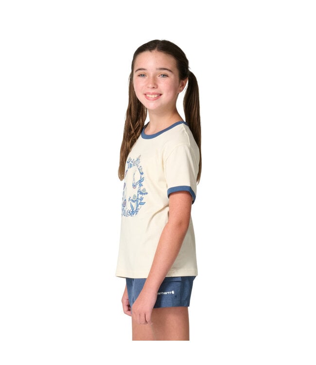 Girl wearing Carhartt Kids cream ringer tee with blue floral C graphic and blue shorts